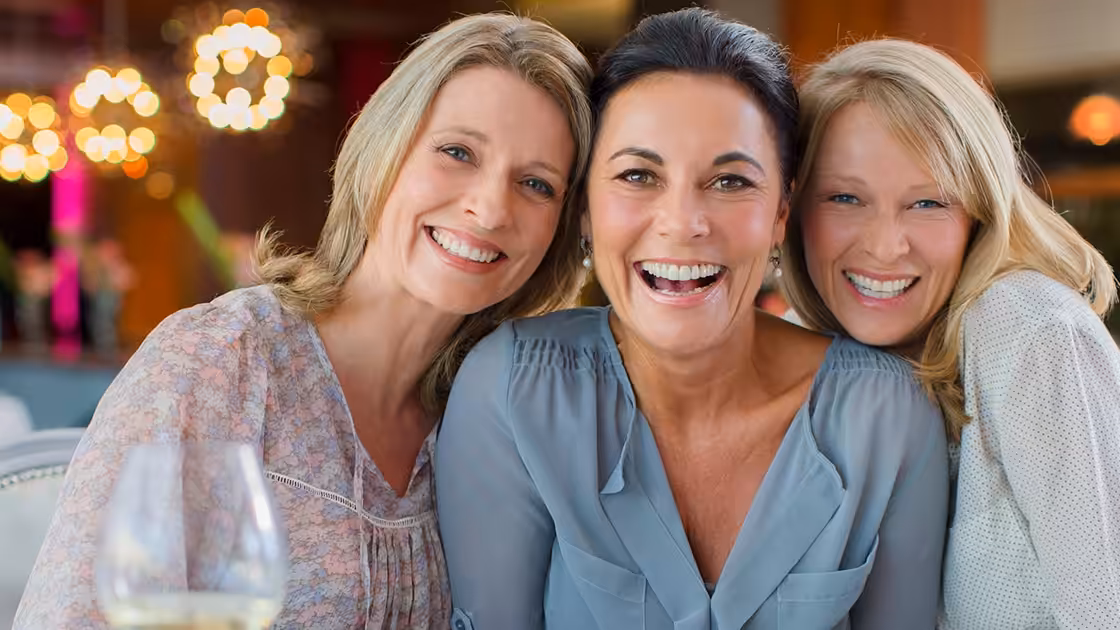 Smiling Women at Dinner